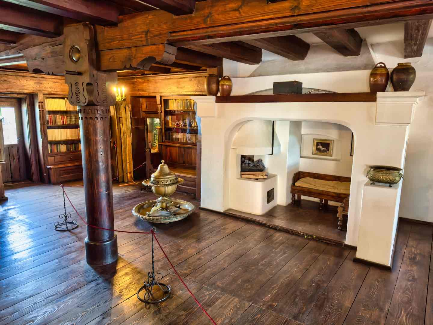 One of the many furnished rooms at Bran Castle showing period wooden furniture and carved details