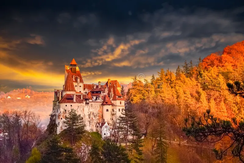 Bran Castle in autumn with surrounding Transylvanian forest in golden colours