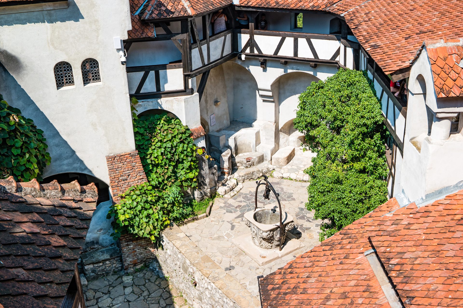 The central courtyard of Bran Castle with the castle well and surrounding medieval towers