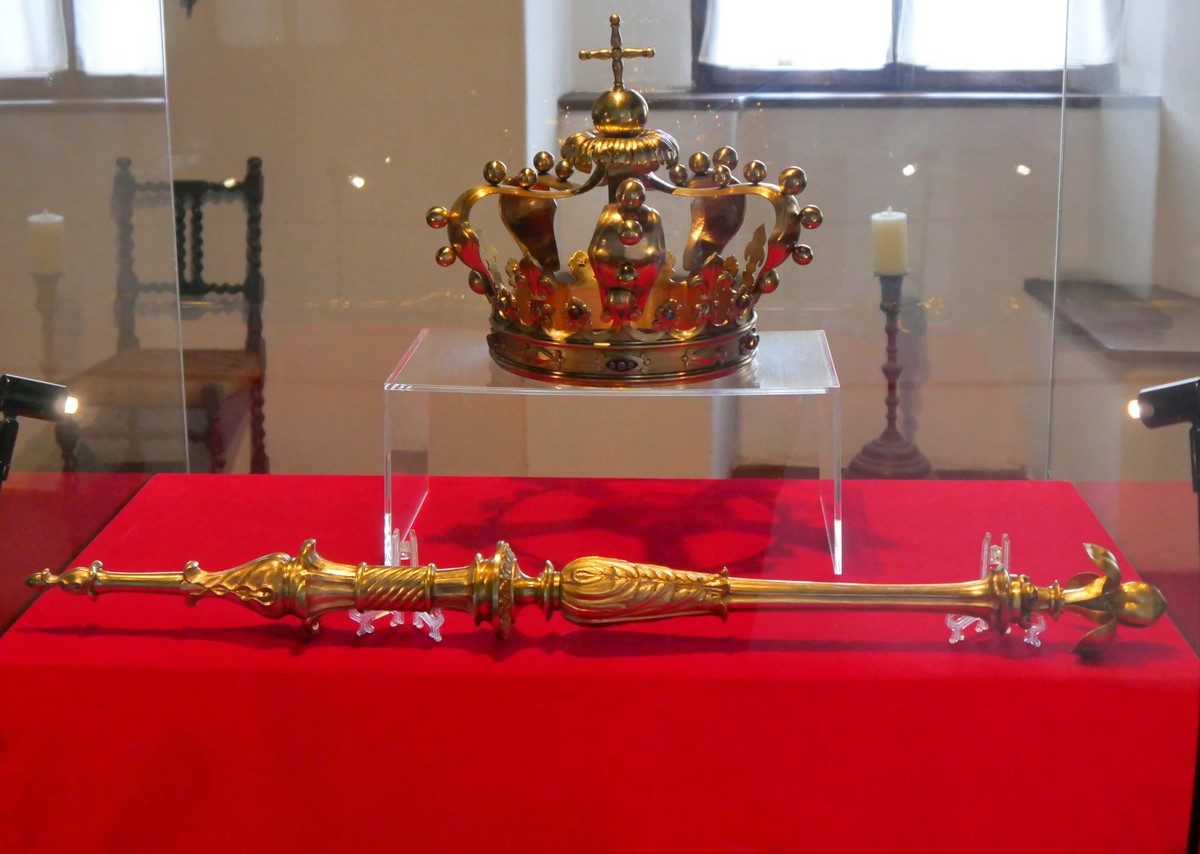 Museum displays inside Bran Castle showing period furniture, weapons, and royal artifacts