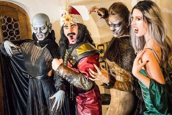 Halloween night at Bran Castle — illuminated medieval towers and costumed visitors at Dracula's Castle
