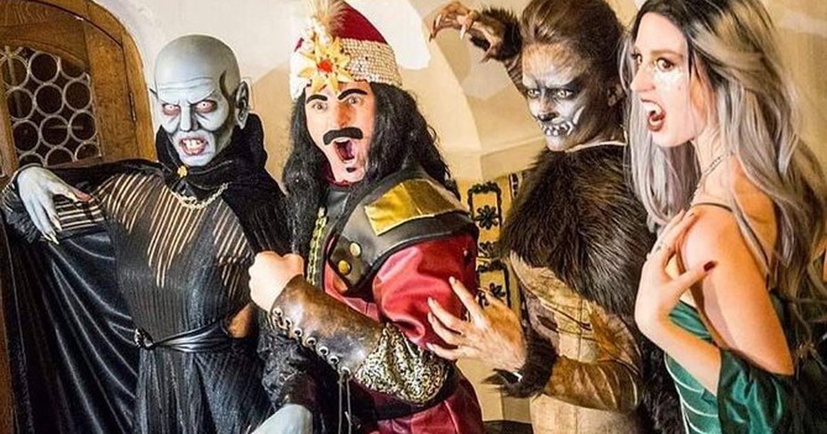 Visitors in elaborate vampire and monster costumes at the Bran Castle Halloween party