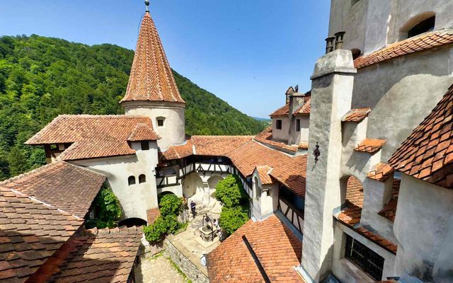 Bran Castle exterior and courtyard on its rocky cliff